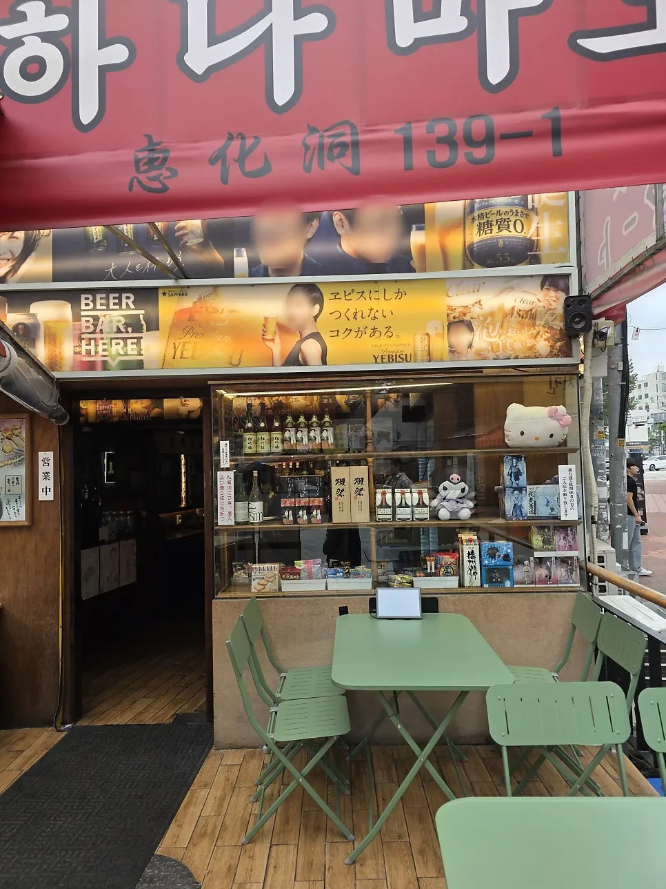 Storefront with red sign and lighting turned on