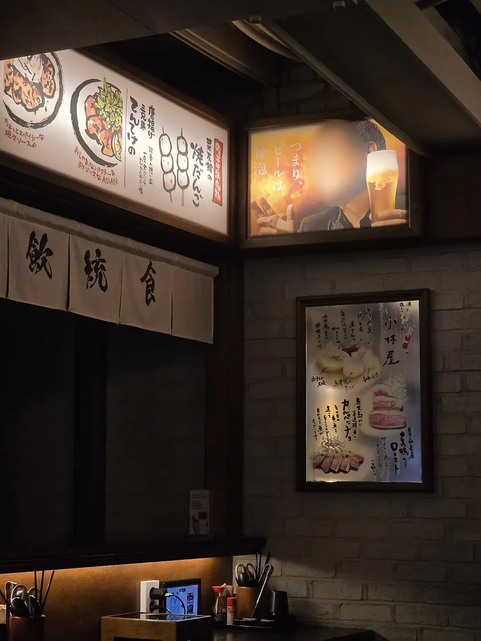Interior with noren curtains and lit-up signs