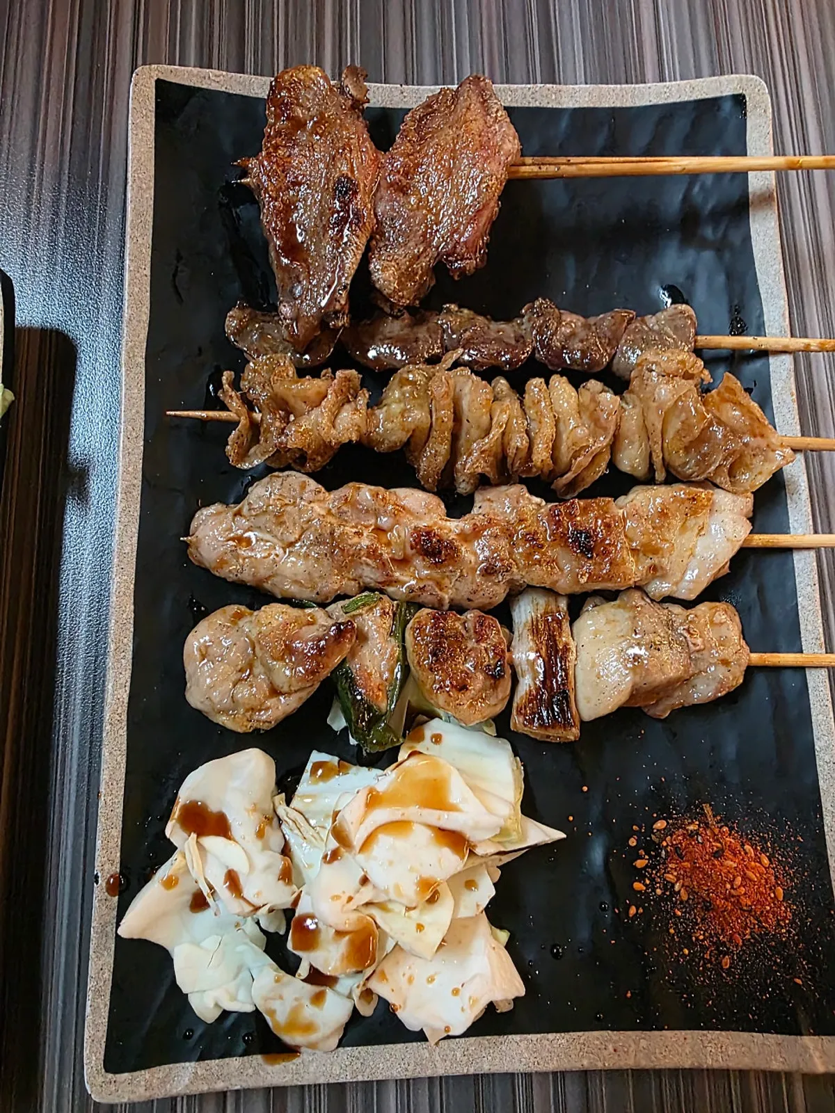 Plate of five yakitori skewers served first