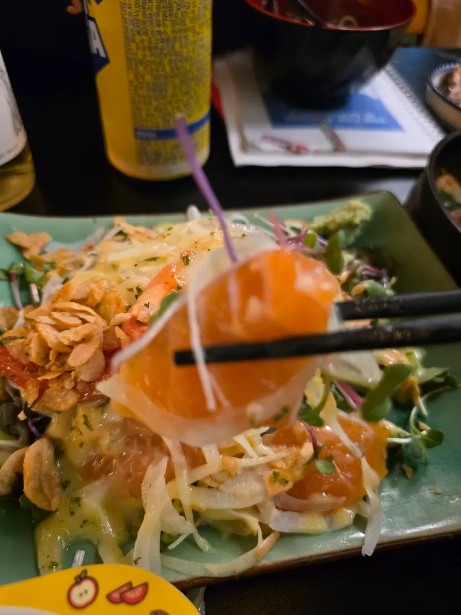 Salmon and salad greens drizzled with yuzu sauce