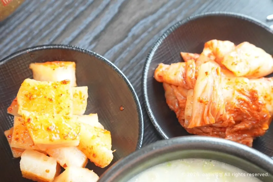 Side dishes of diced radish kimchi and napa cabbage kimchi