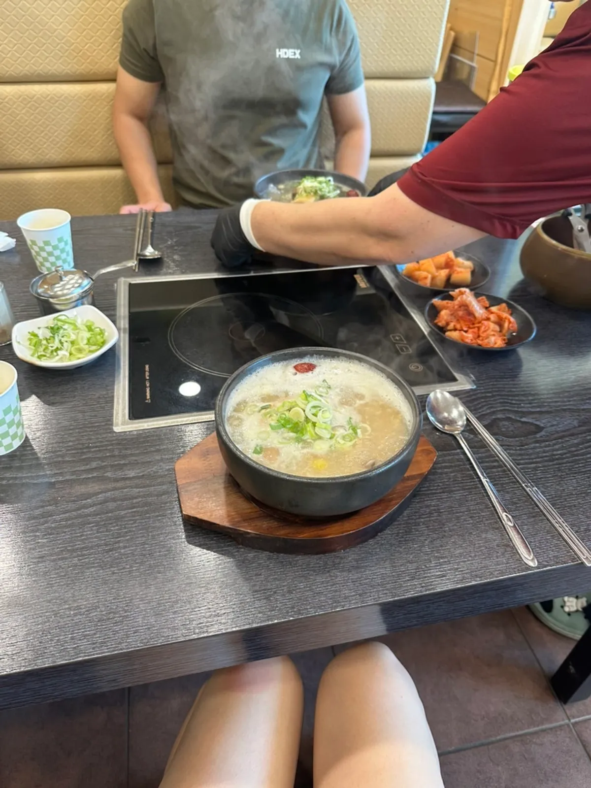 Table spread of nurungji half-chicken samgyetang and royal galbitang