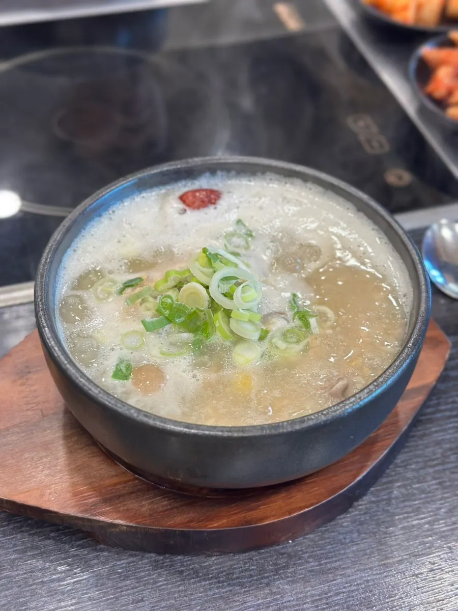 Nurungji half-chicken samgyetang served in a stone bowl
