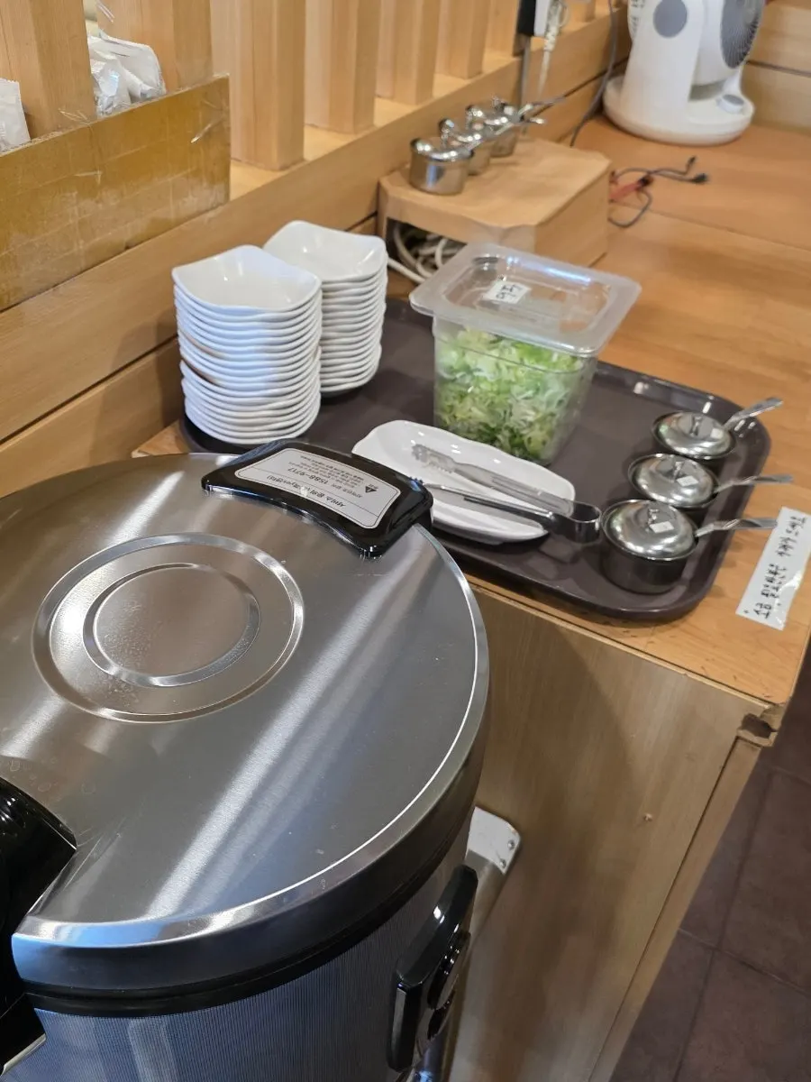 Self-serve corner with wet towels and aprons