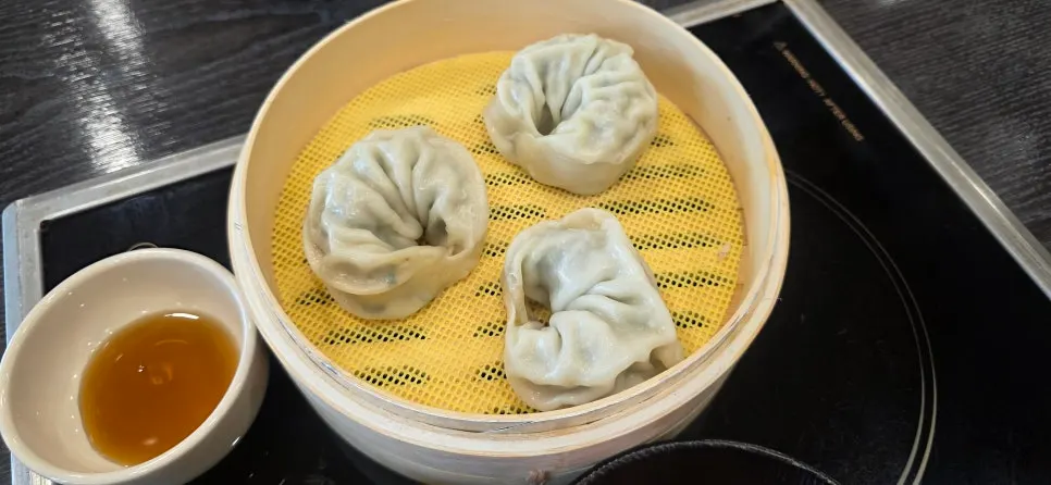 Three plump mandu served with dipping sauce