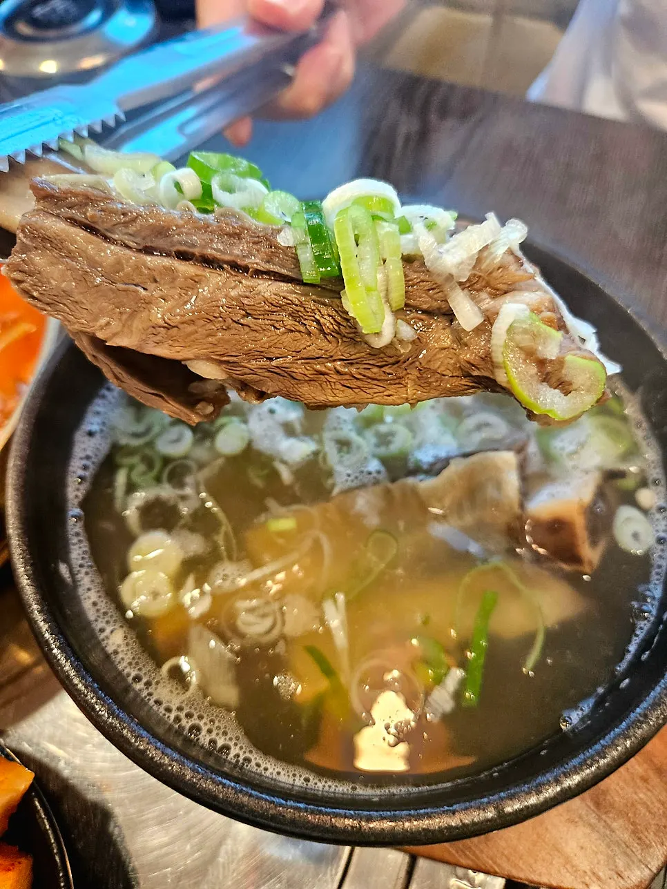 Galbitang topped with enoki mushrooms and jujube