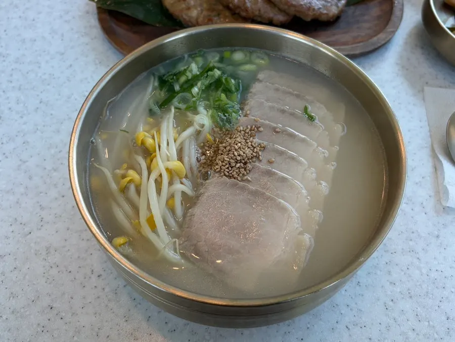 Table set with pork noodles, bibim noodles, and tteokgalbi
