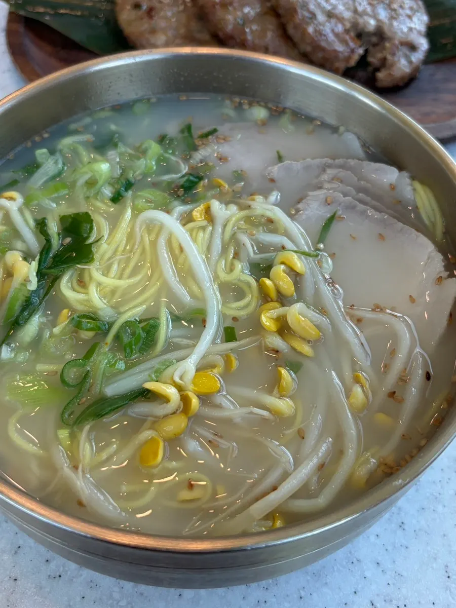 Bean bone broth pork noodles topped with bean sprouts