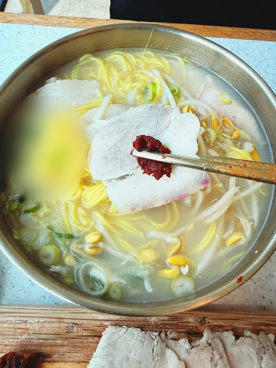 Close-up of the bone broth in the pork noodle soup