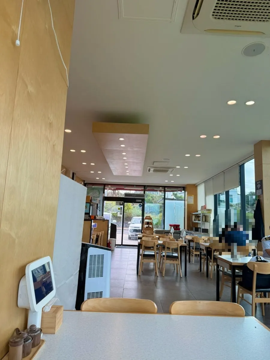 Ocean-view seating with Jeju's sea visible through the window