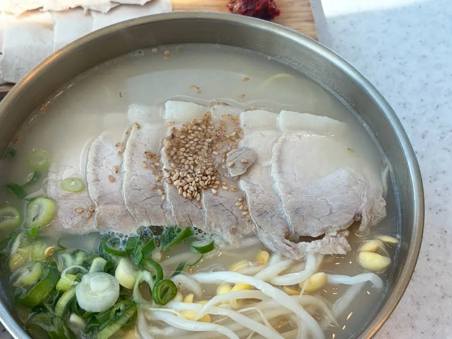 Pork noodle soup topped with thick slices of boiled pork