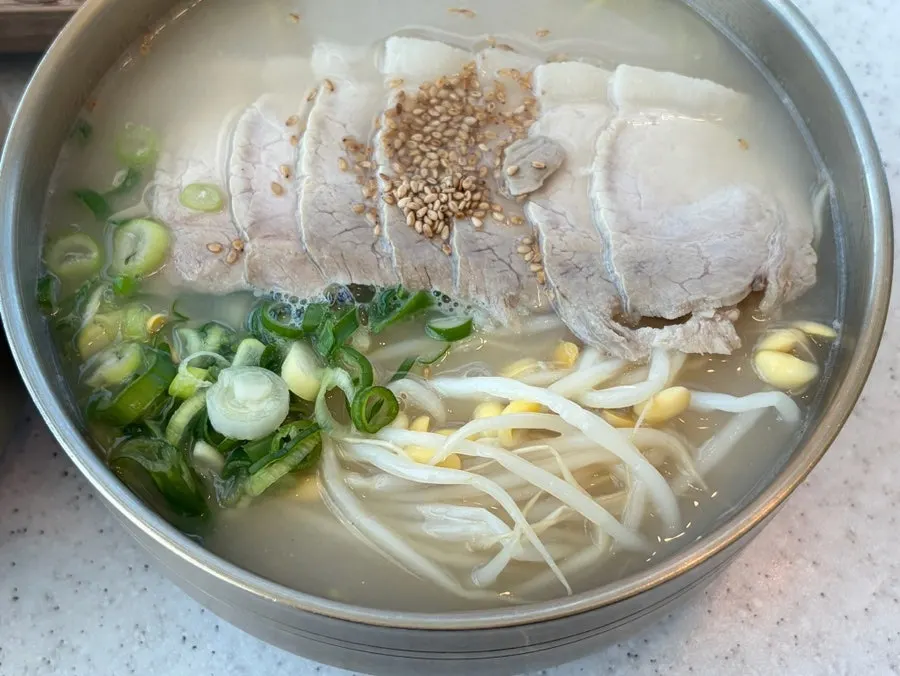 Pork noodle soup packed with bean sprouts and scallions