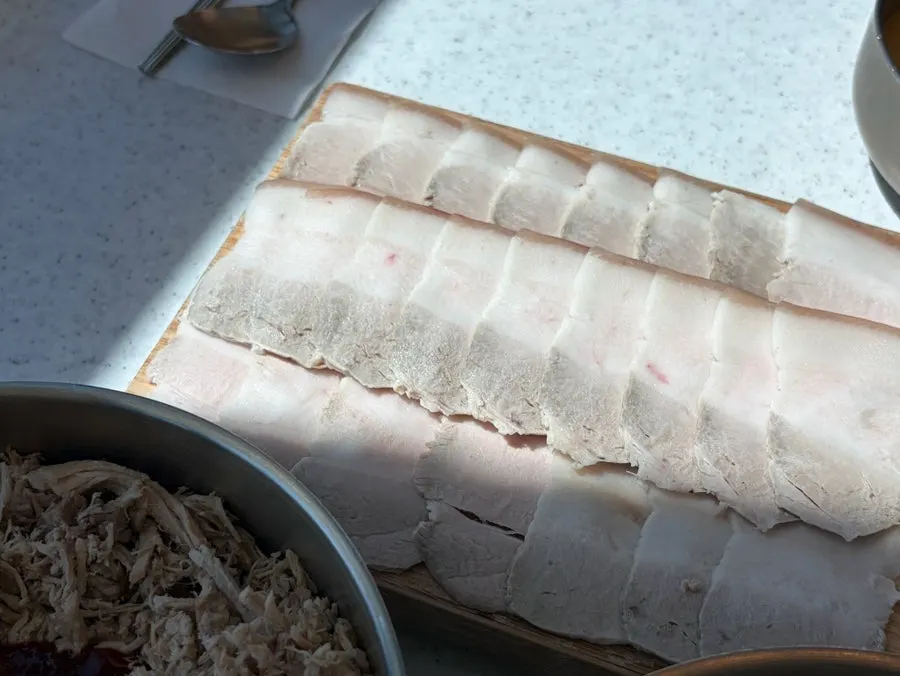 Table with both the boiled pork and the noodles