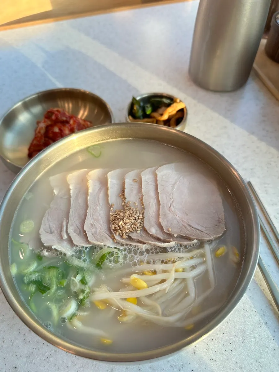 Pork noodle soup photographed against the ocean view