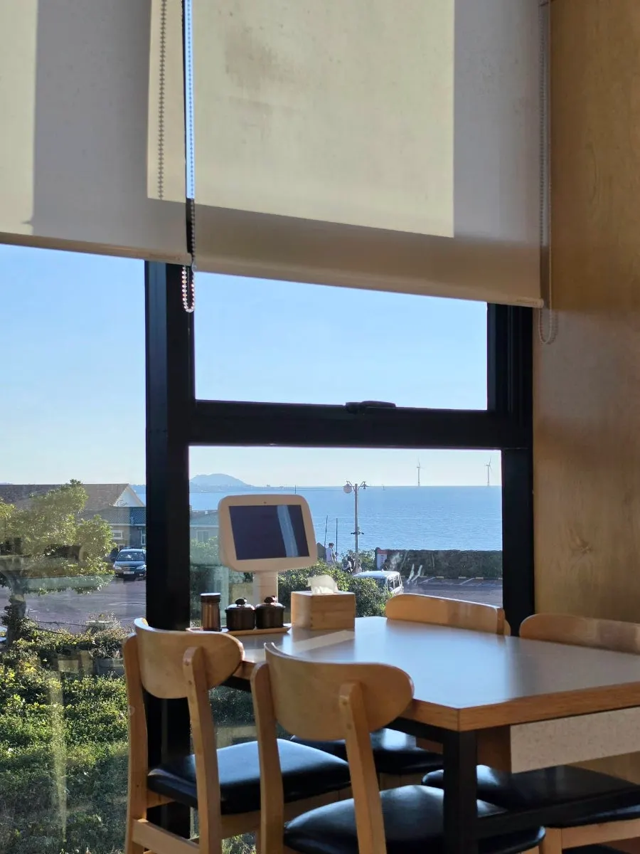 The Aewol sea seen through the restaurant window at sunset
