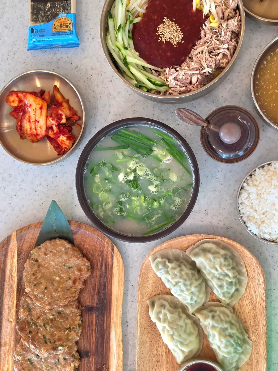 Table set with extra-large dongchimi bibim noodles and salgogi gukbap