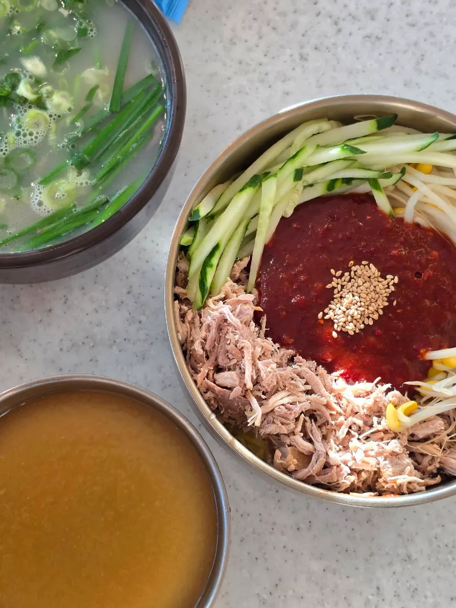 Bibim noodles eaten with dongchimi broth
