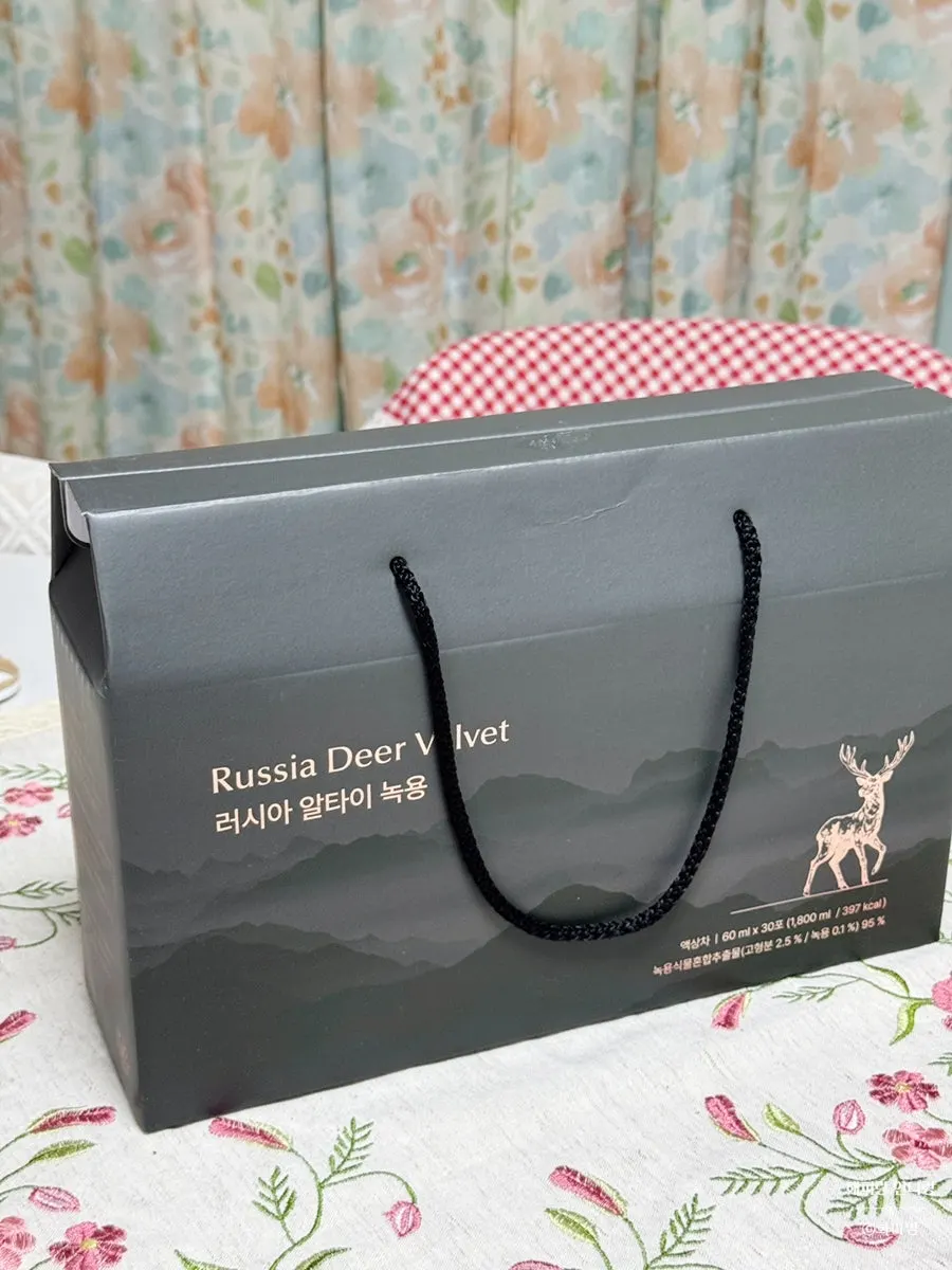 Black-toned individual pouch engraved with a deer symbol