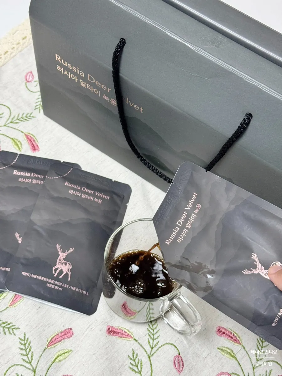 Dark brown deer antler juice poured into a glass