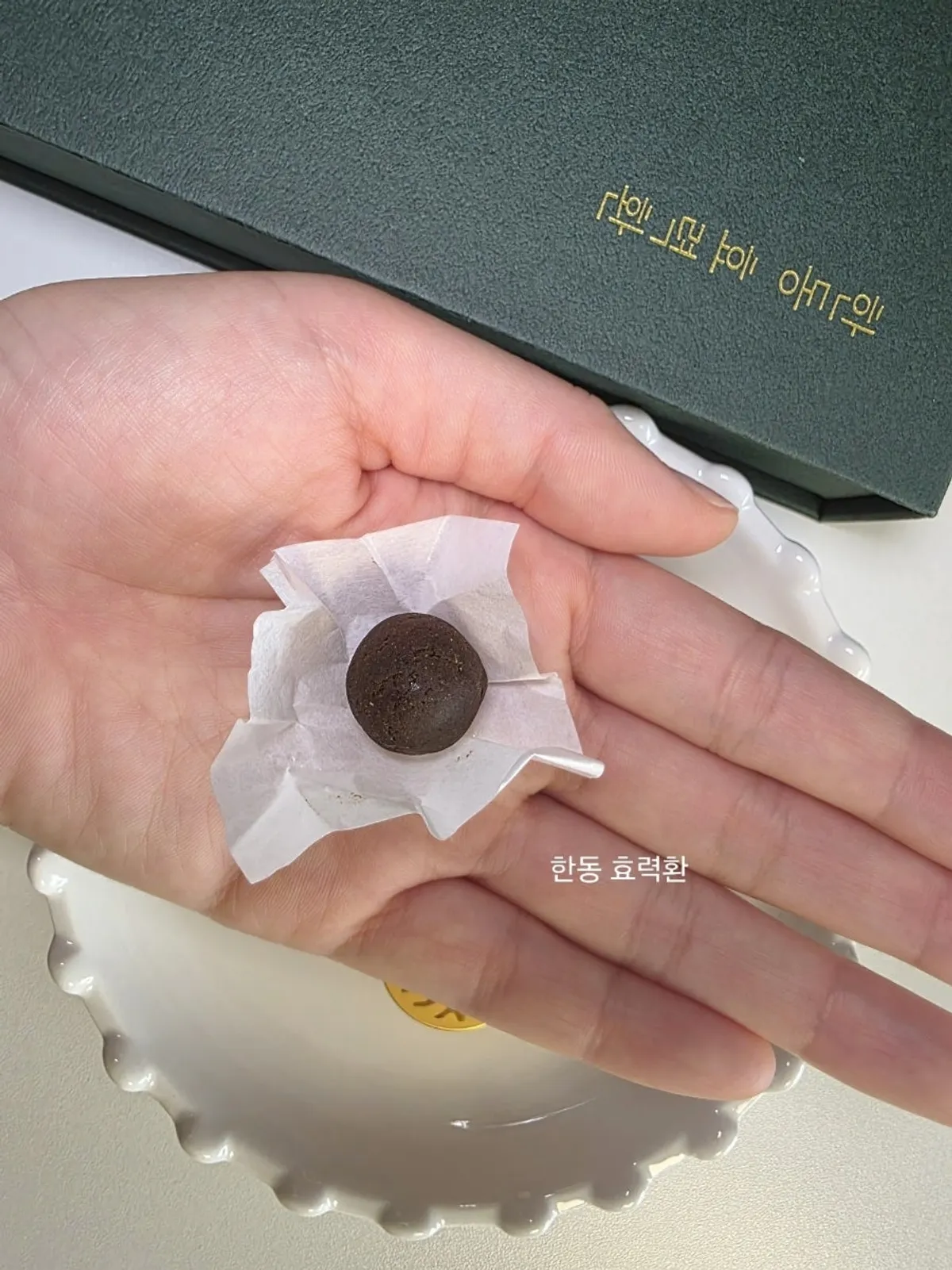 A Handong Hyoryeokhwan pill held in hand