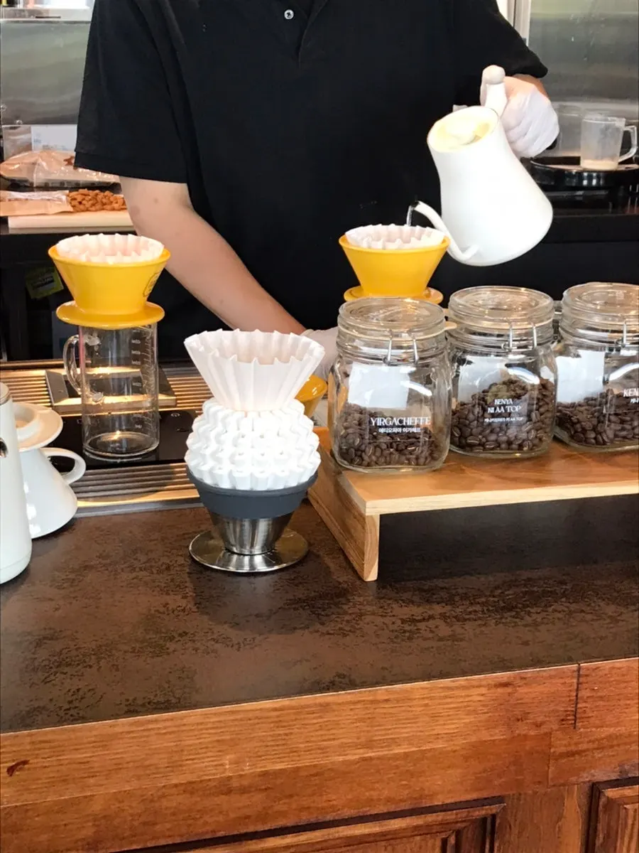 Barista brewing hand-drip coffee at the bar