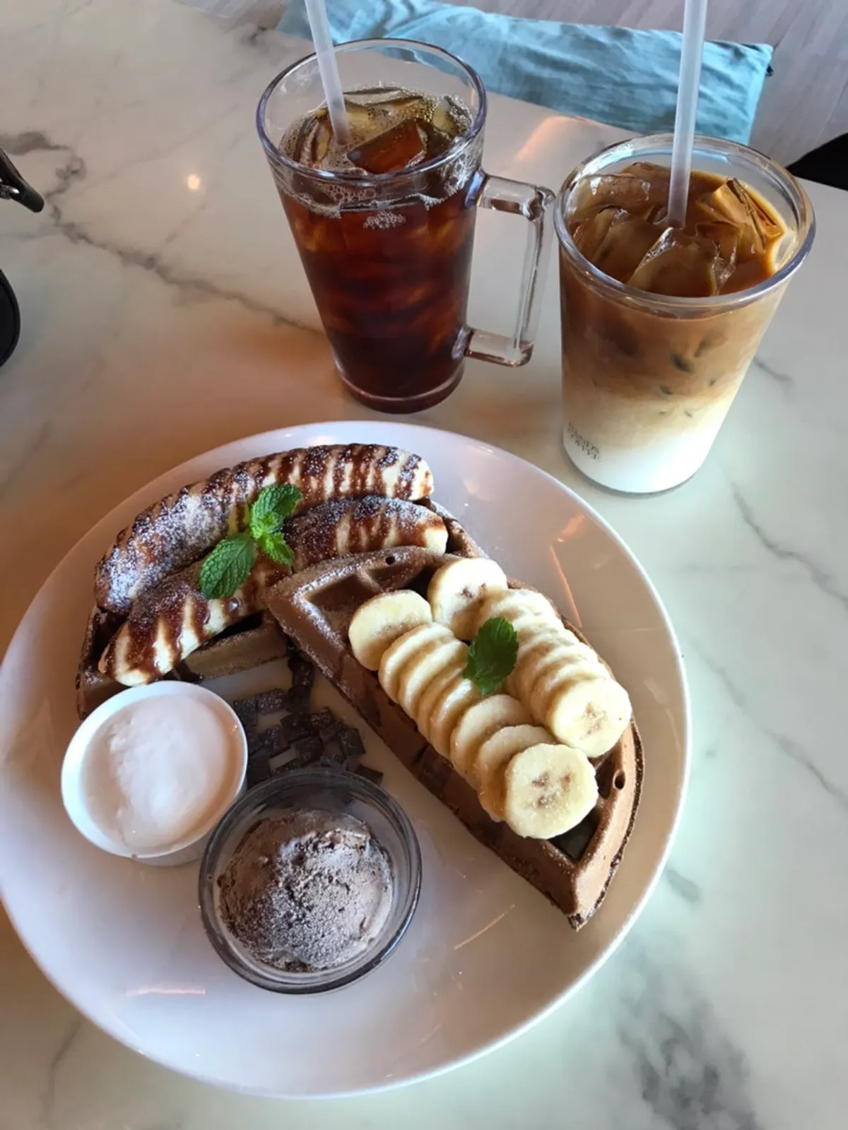 Chocolate banana waffle with two cups of coffee