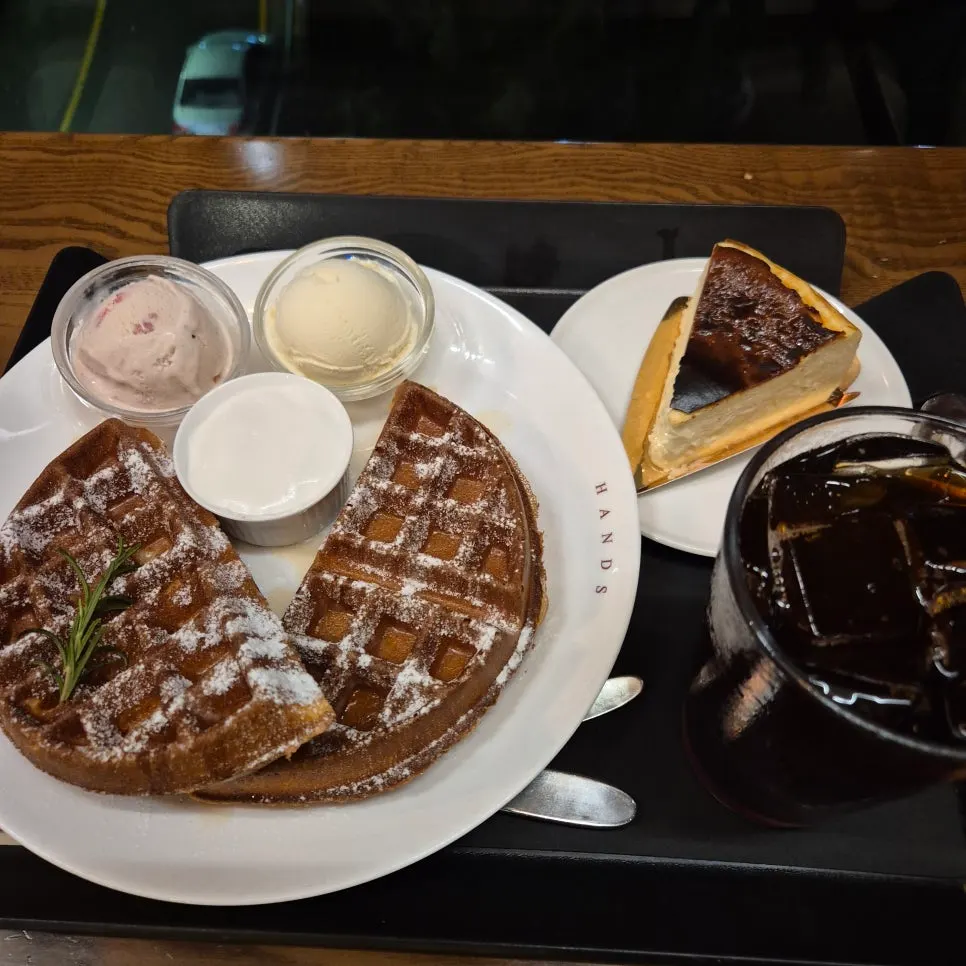 Waffle, coffee, and cheesecake on the table