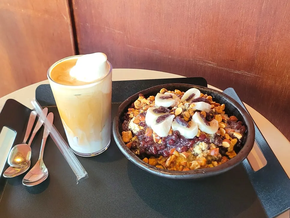 Patbingsu and ice cream latte set out at a window seat