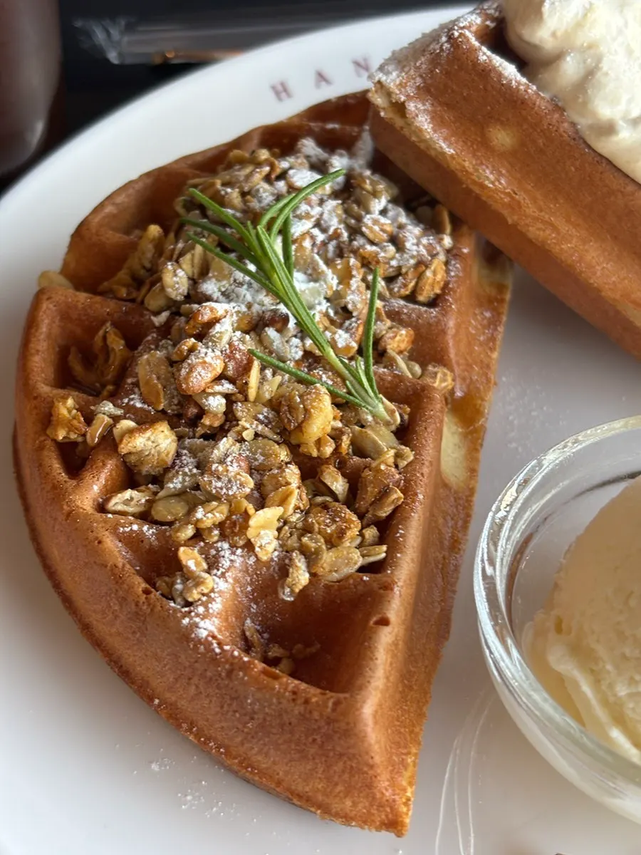 Close-up of the waffle topped with peanut cream and granola