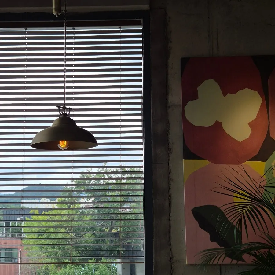 Café wall hung with paintings and photos
