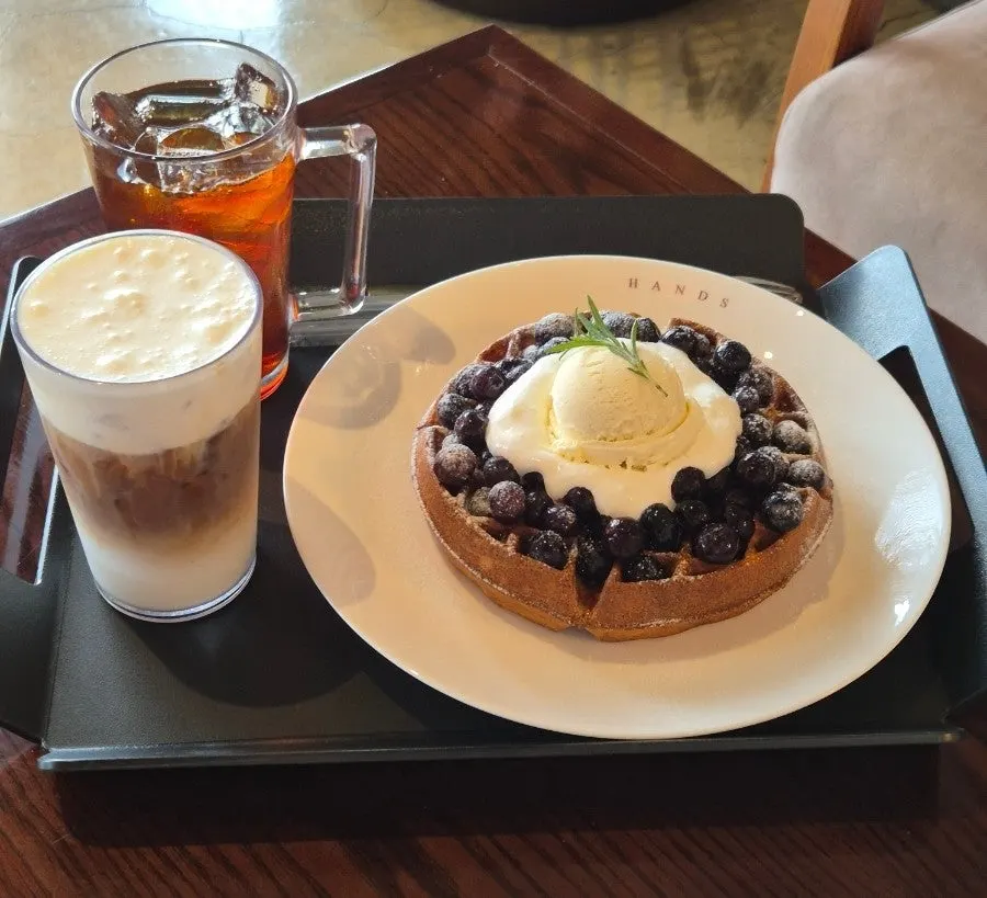 Table setting with waffle, drip coffee, and Dutch latte