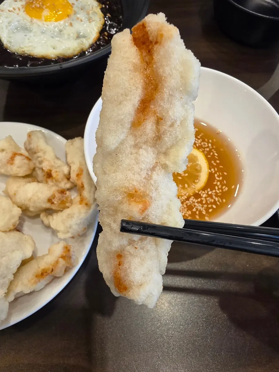 Dipping tangsuyuk into the sauce