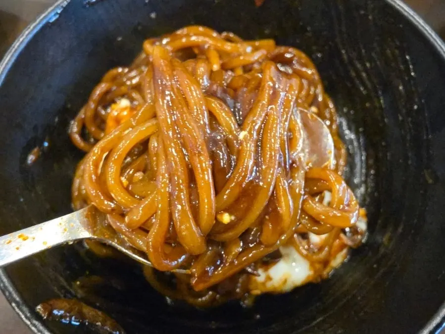 Chopsticks lifting mixed jjajangmyeon noodles