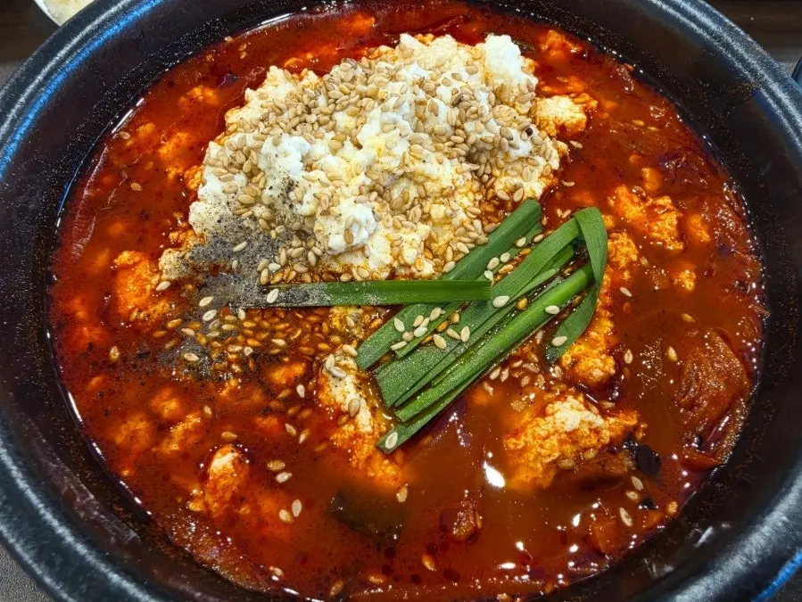 Spoonful of soft tofu and jjamppong ingredients
