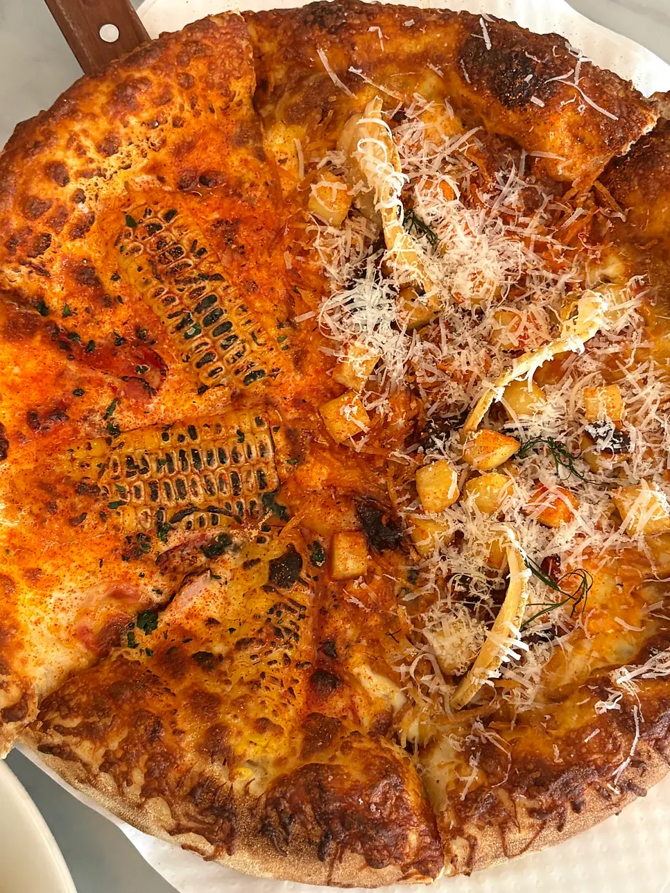 Half-and-half pizza with corn and potato toppings