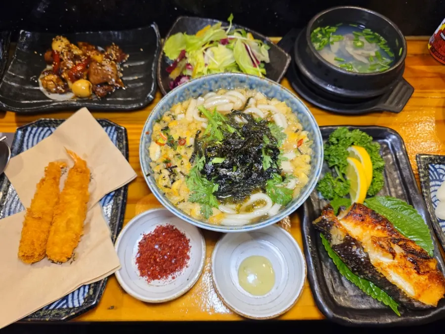 A full spread of banchan laid out on the table