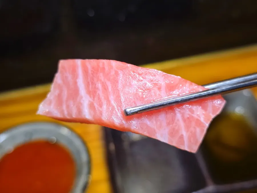Close-up of tuna sashimi cuts arranged by part