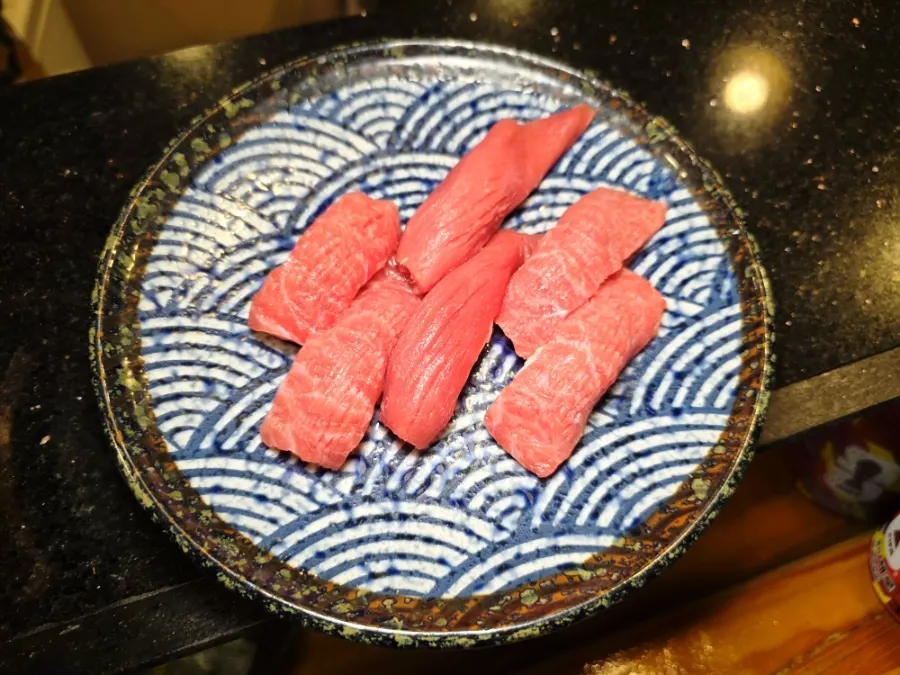 A plate of tuna sashimi with plenty still left