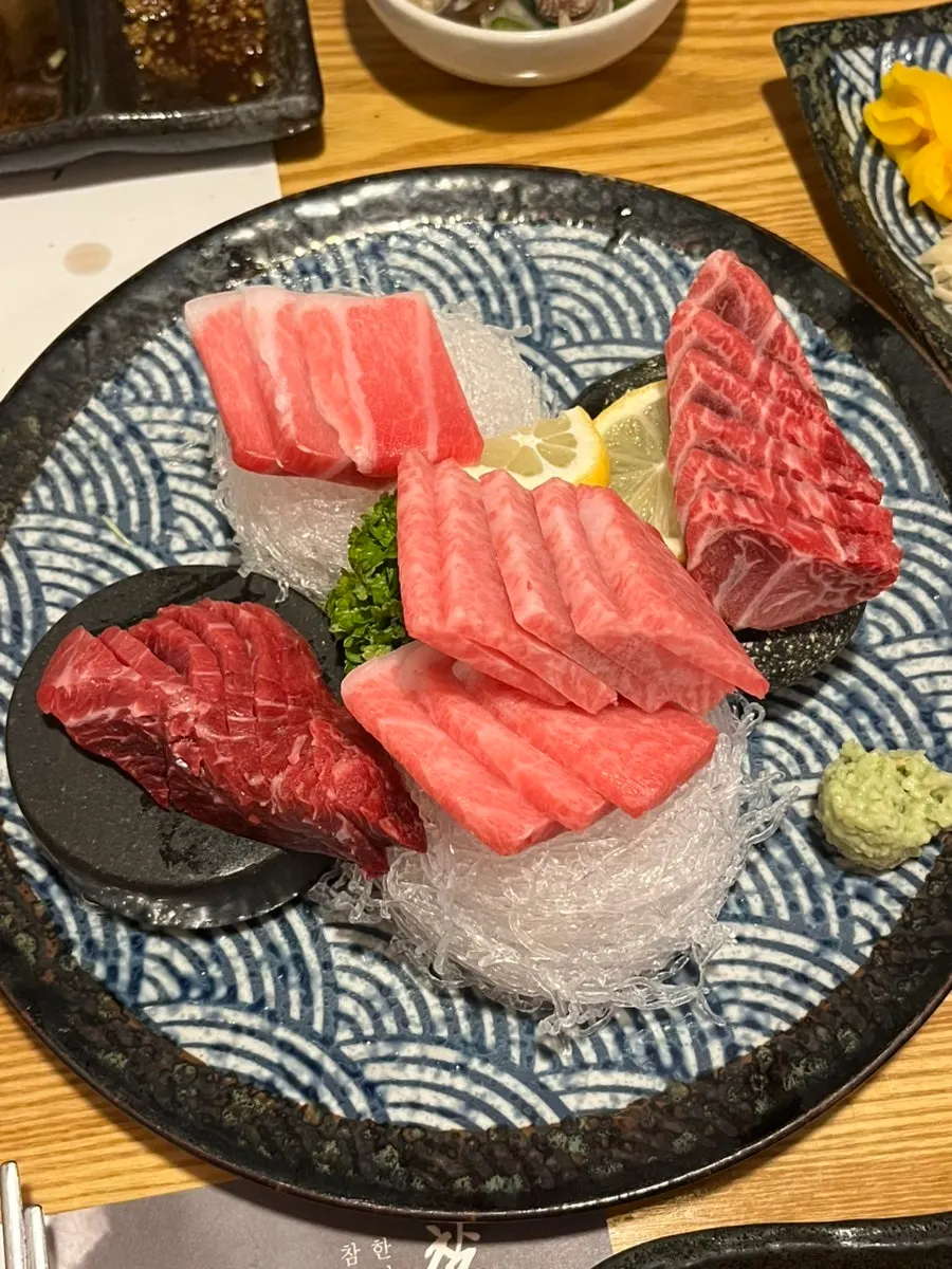 A plate of aged tuna showing lean and fatty cuts