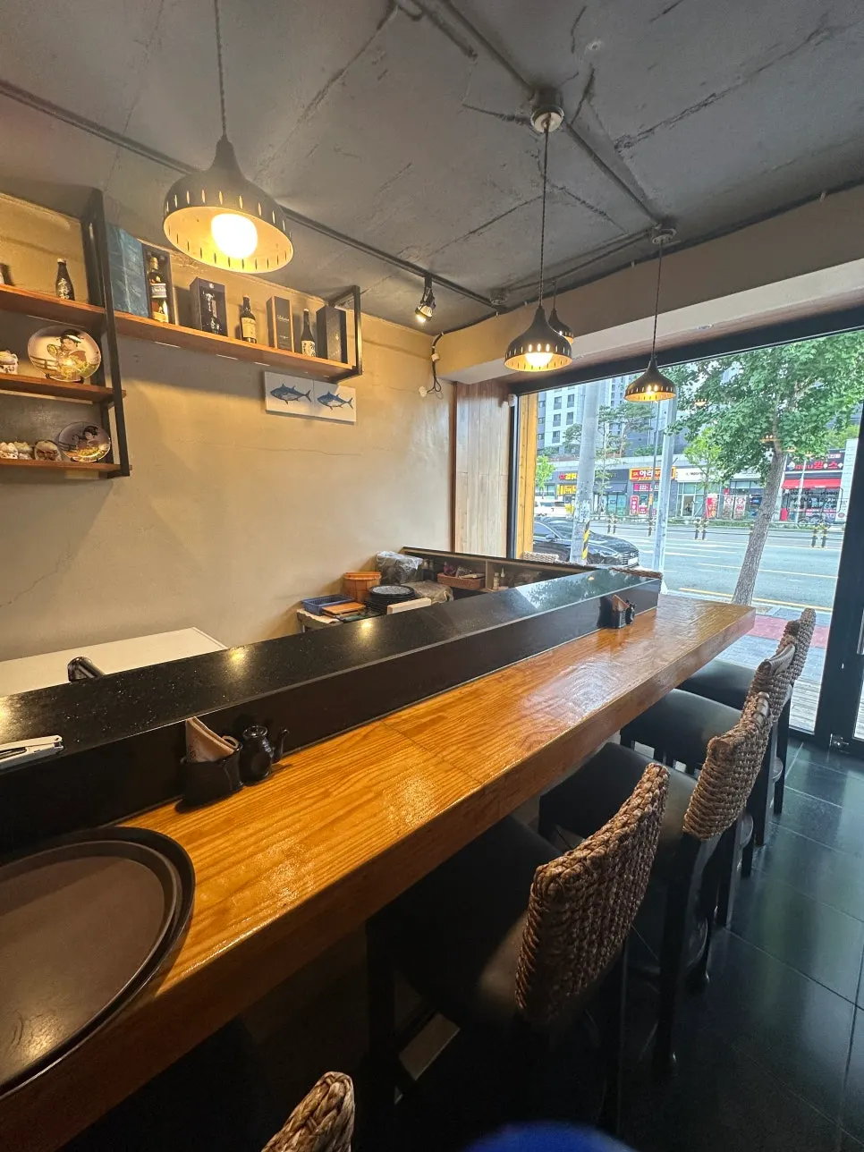 Long, lit-up bar seats in front of the kitchen