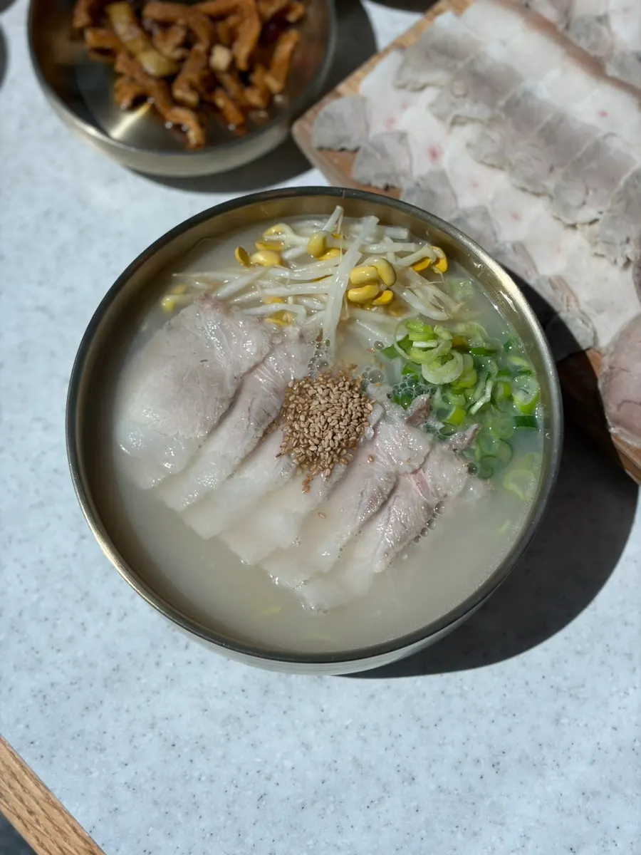 Noodle table set by the window with an ocean view
