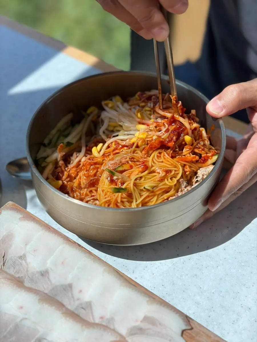 Dongchimi bibim noodles loaded with bean sprouts