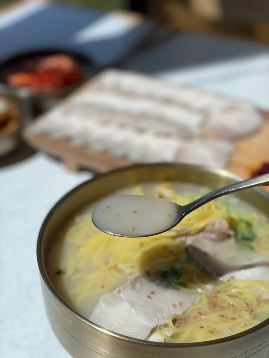 A bowl of pork noodles in rich bone broth