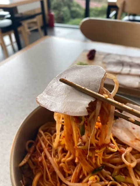 Dongchimi bibim noodles topped with finely shredded meat