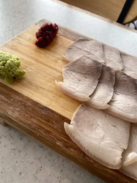 Close-up showing the thickness of the dombe naengsuyuk slices