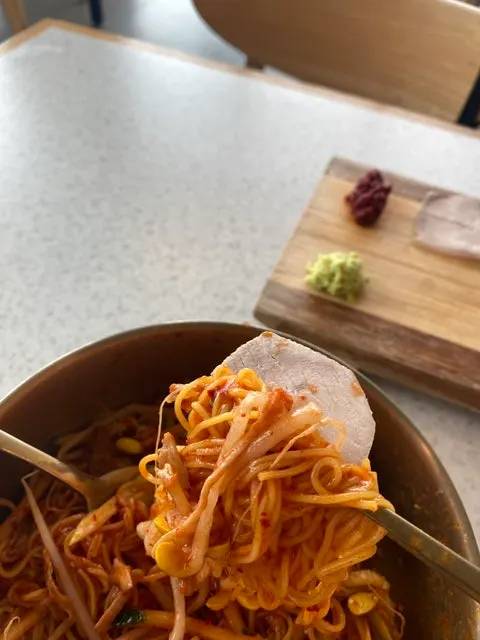 Table setting with boiled pork and noodles together