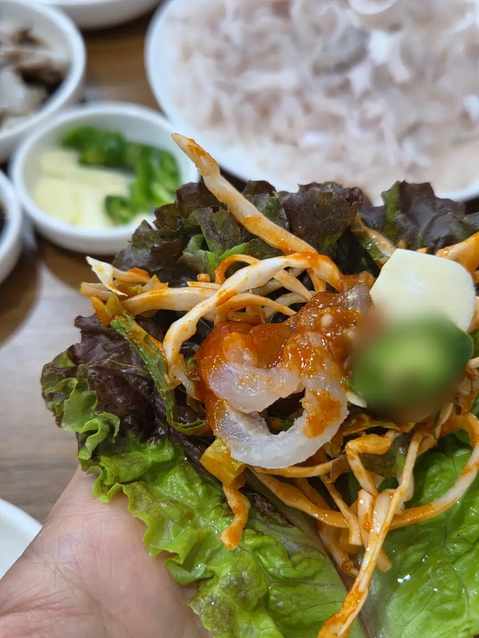 Chamgajami sashimi wrap with lettuce and perilla leaves