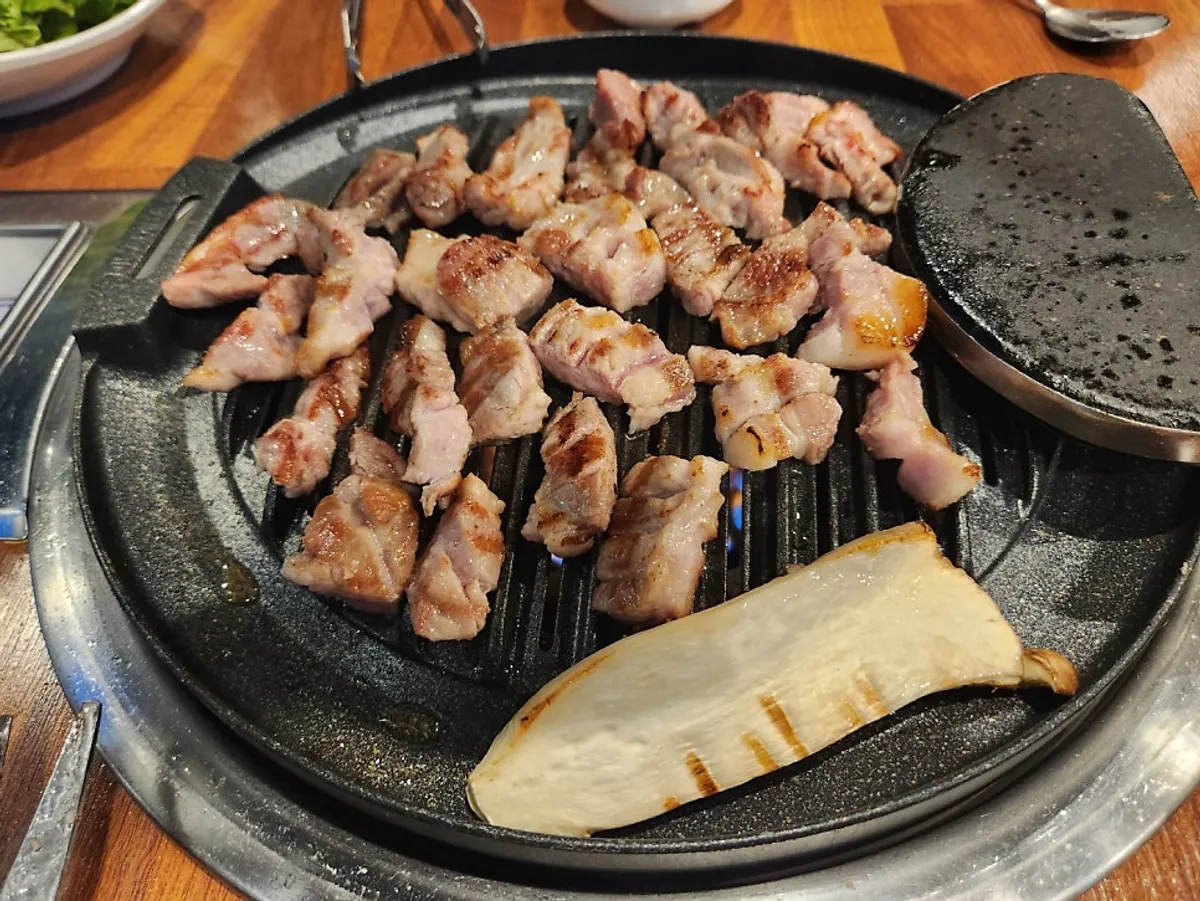 Aged pork grilling over charcoal