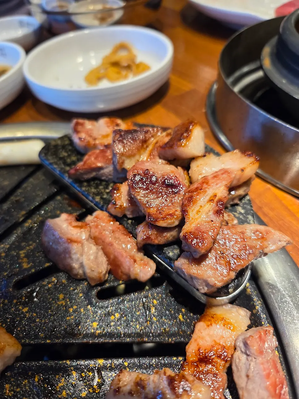 Samgyeopsal and mokssal cooking on the grill
