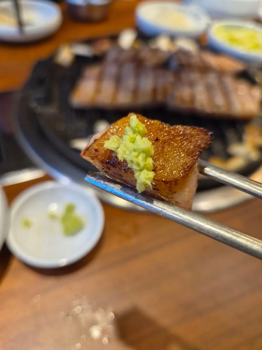 A piece of aged pork picked up with chopsticks